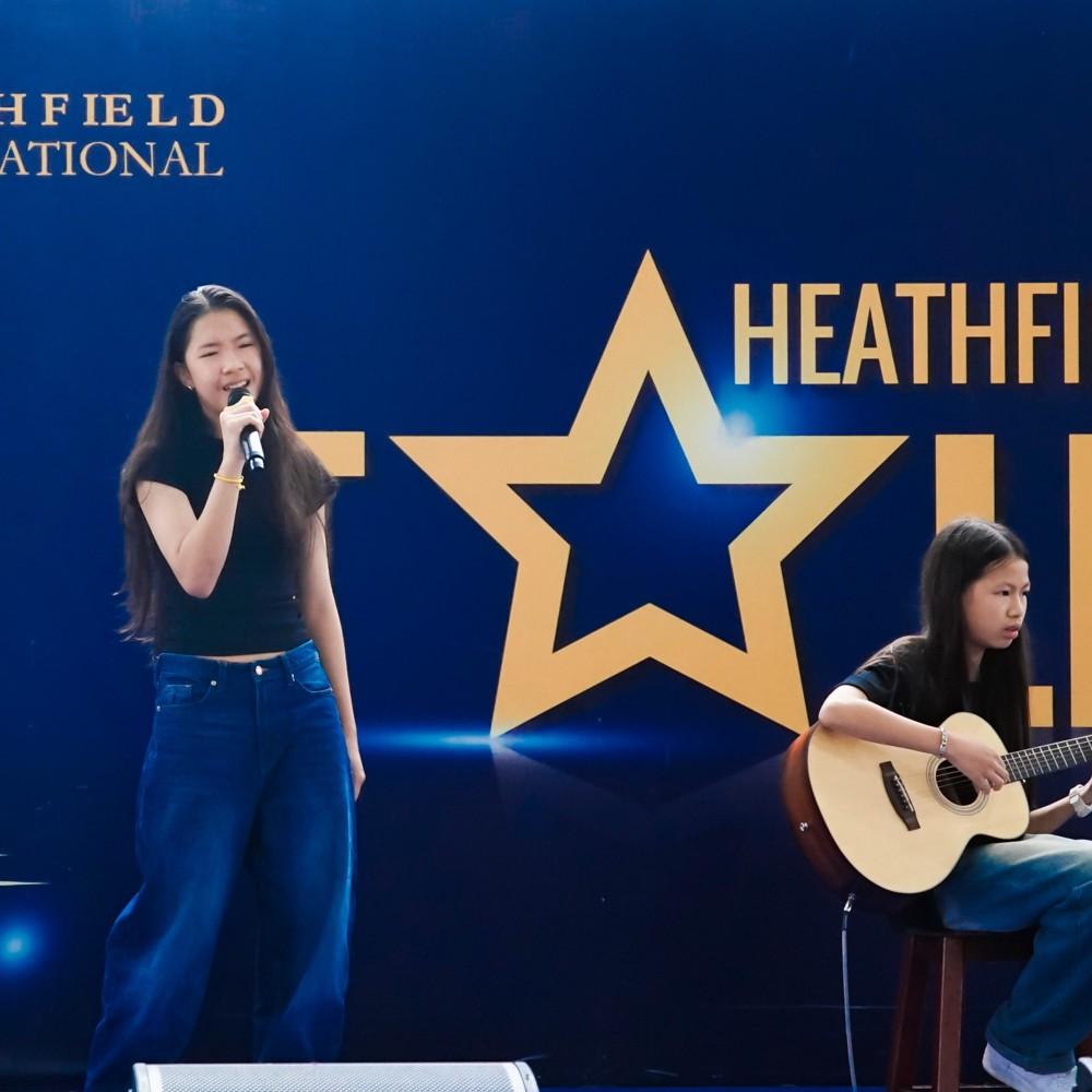 Singer and guitarist team up for a musical performance at the talent show.