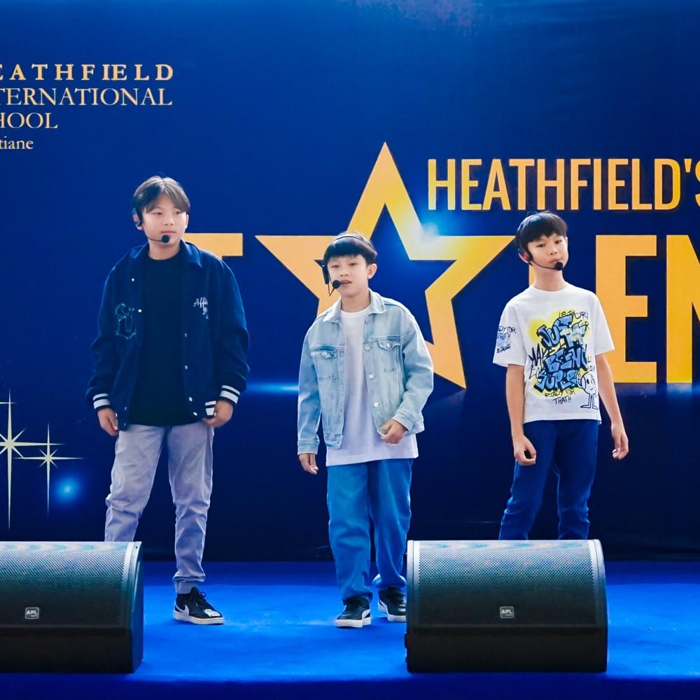 Group of students singing on stage.