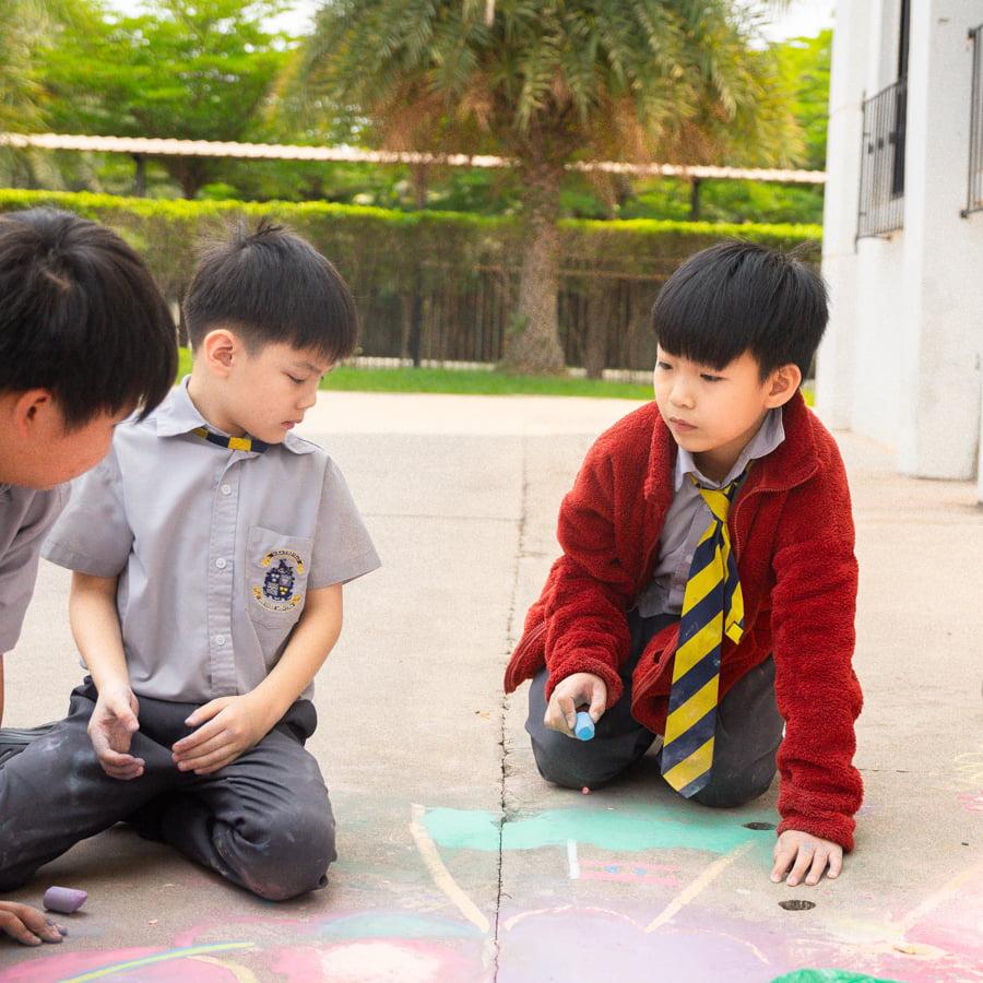 Students working on chalk art for inclusion week