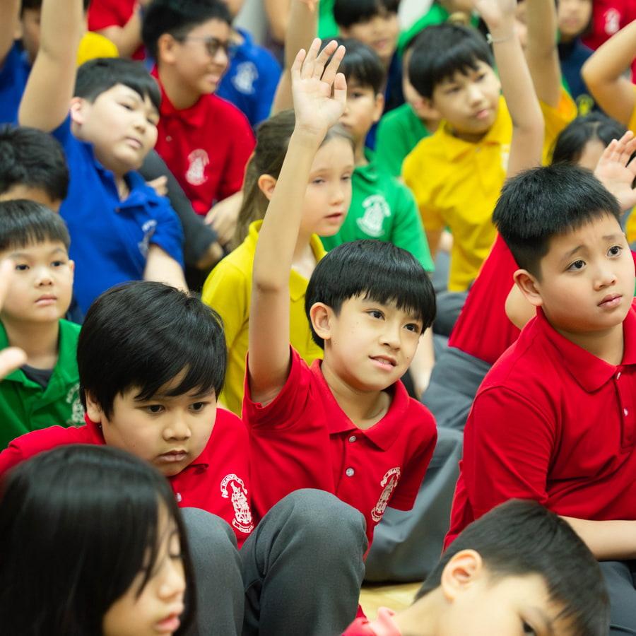 Children raising their hands