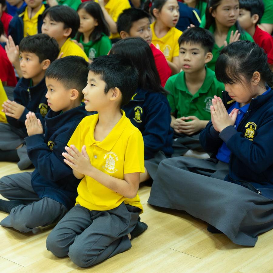 Young students putting their hands together