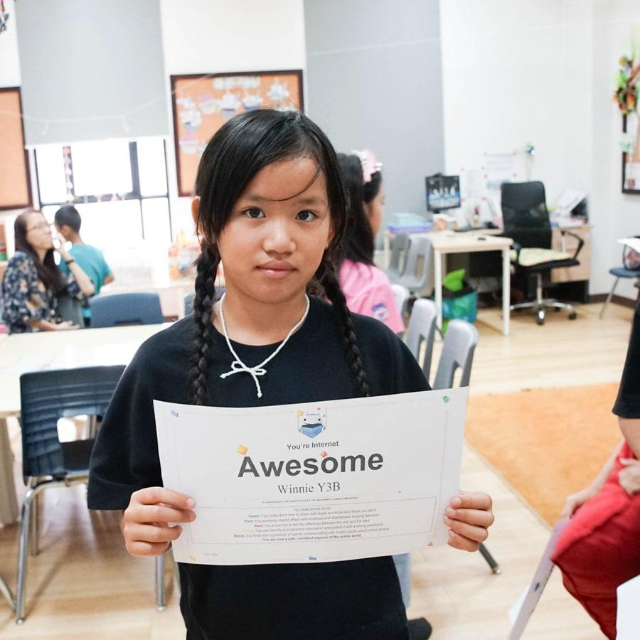 Student holding a certificate of achievement
