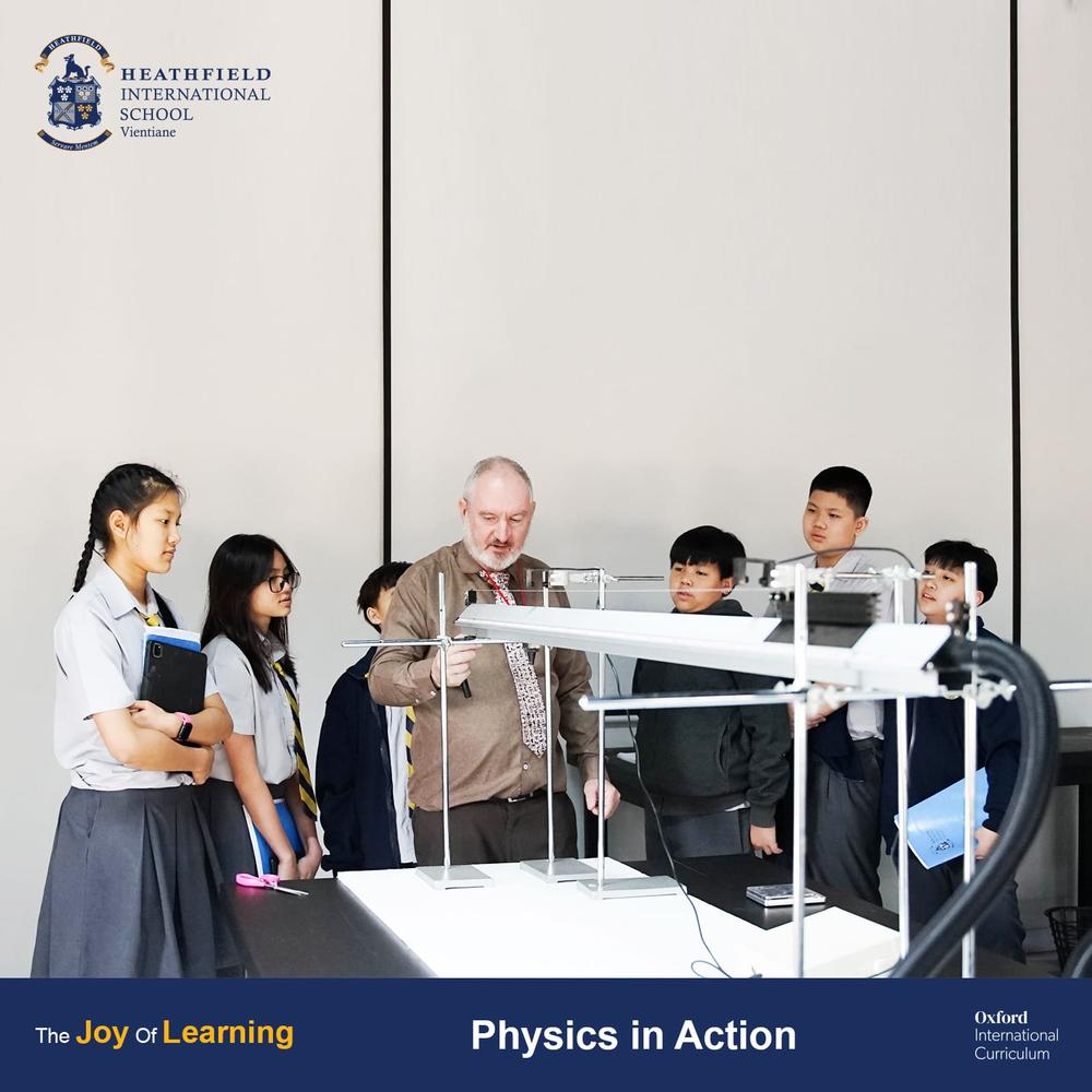 Teacher demonstrating physics experiment to the class