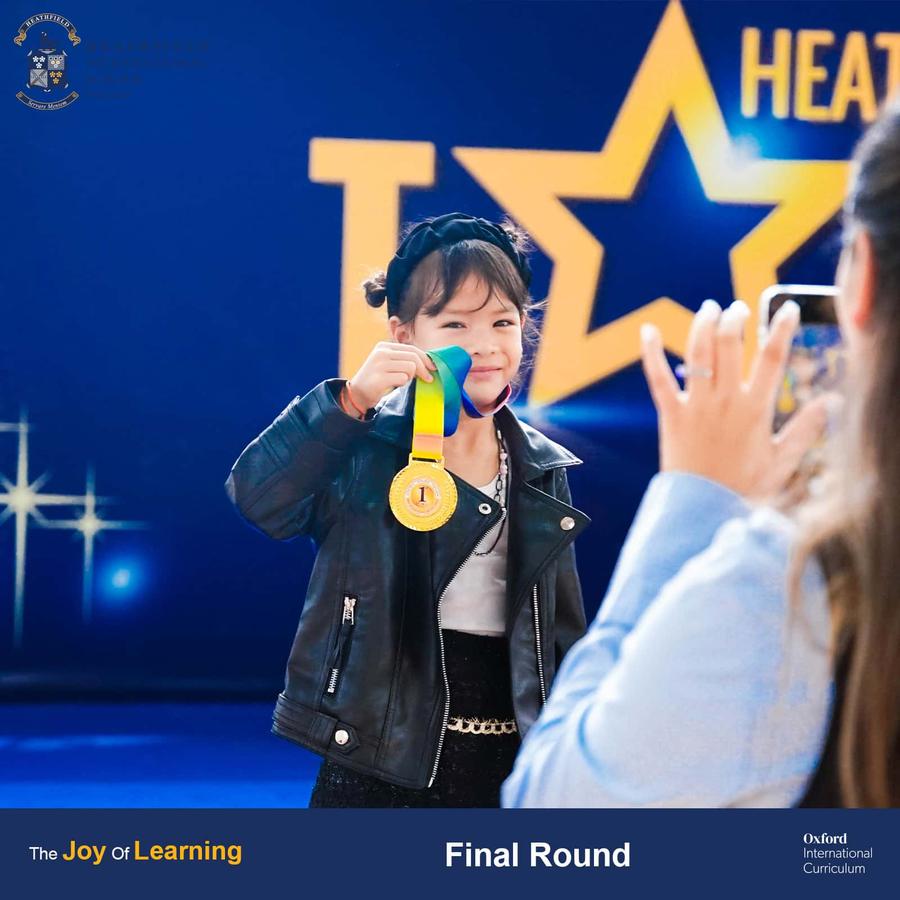 First-place winner in the Year 1-3 category holding their award medal at Heathfield's Got Talent finals.