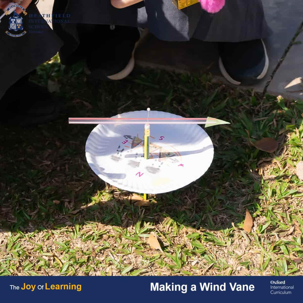 A close-up view of a completed wind vane placed on the grass, showcasing its design and functionality.